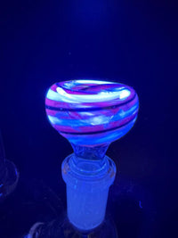Filla John Black Light UV 14mm Bowl glowing under black light, featuring vibrant colors and a unique swirl design.