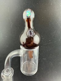 Windstar Glass Bubble Cap atop a clear quartz banger, designed for enhanced airflow and vaporization during dabbing.