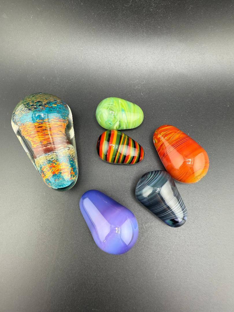 Colorful assorted handcrafted marbles from Paulson Pieces, showcasing vibrant designs and smooth finishes.