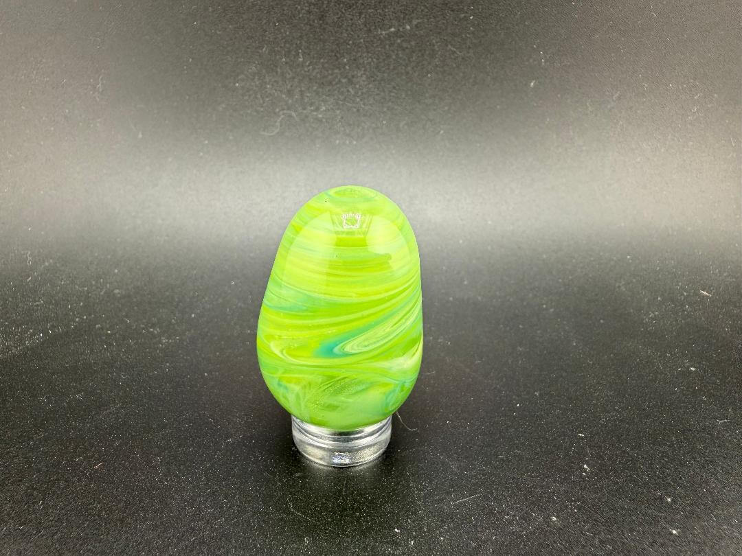 Handcrafted green Easter egg marble by Paulson Pieces, showcasing vibrant swirls and unique design, made in Spokane, WA.