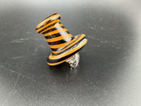 Black and orange spinner cap with striped design, set against a dark background, ideal for themed parties.