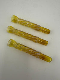 Three yellow handcrafted glass pinch hitter pipes for discreet smoking sessions.