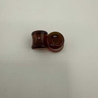 Paulson Pieces 9mm ear plugs made from handcrafted borosilicate glass in a rich amber color.
