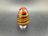 Colorful handcrafted Paulson Pieces Easter Egg Marble in vibrant stripes of red, black, yellow, and green.