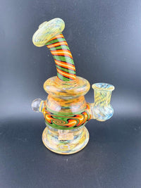 Colorful handcrafted glass rig with spiral design, perfect for dabbing. Crafted with attention to detail and style.