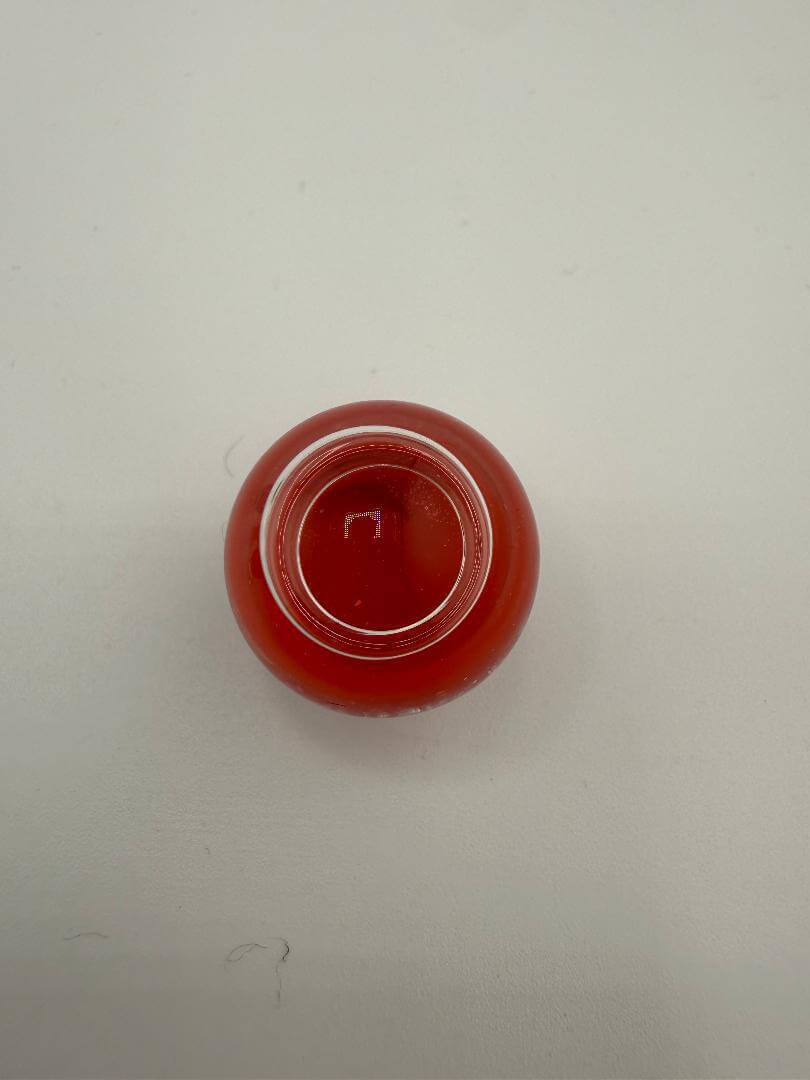 Top view of a vibrant red Paulson Pieces marble slurper top, handcrafted for enhanced heat retention in dab setups.