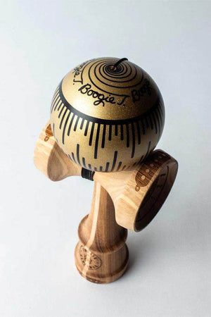 A decorative wooden kendama toy with a gold-painted ball and intricate patterns.