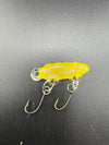 Handcrafted yellow glass fishing lure by Paulson Pieces, featuring unique design and durable hooks.