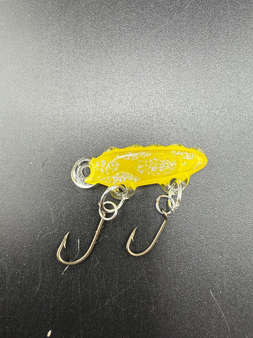 Handcrafted yellow glass fishing lure by Paulson Pieces, featuring unique design and durable hooks.