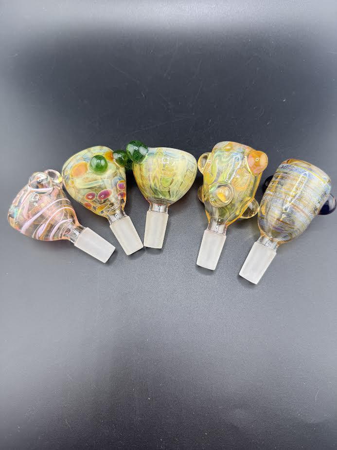 Colorful collection of handblown glass bowl pieces, featuring unique designs and fume work, ideal for 14mm slides.