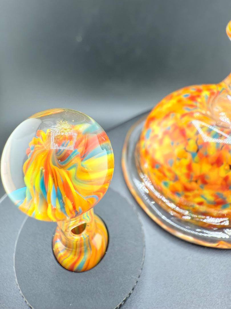 Colorful Paulson Pieces Dr. Dabber Switch 2 replacement glass and cap, featuring vibrant orange and blue confetti design.