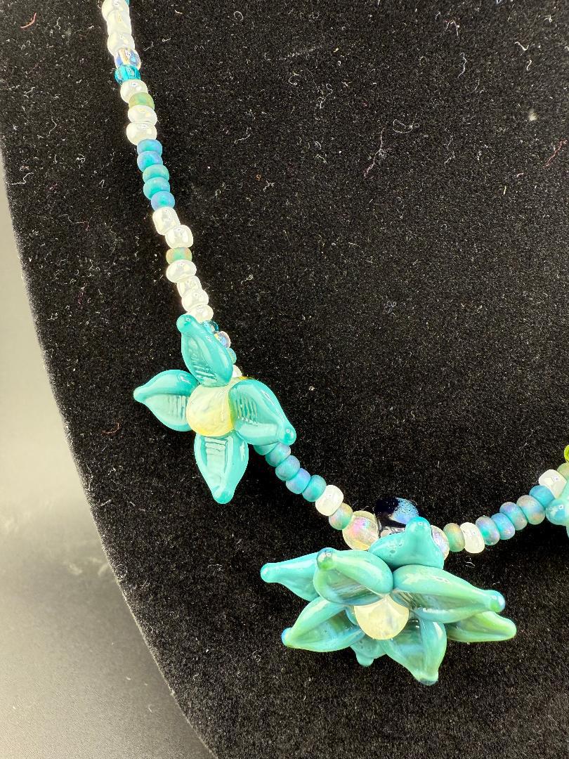Handmade Pablos Glass Flower Beaded Necklace featuring blue floral glass beads and delicate accents for a boho-chic style.