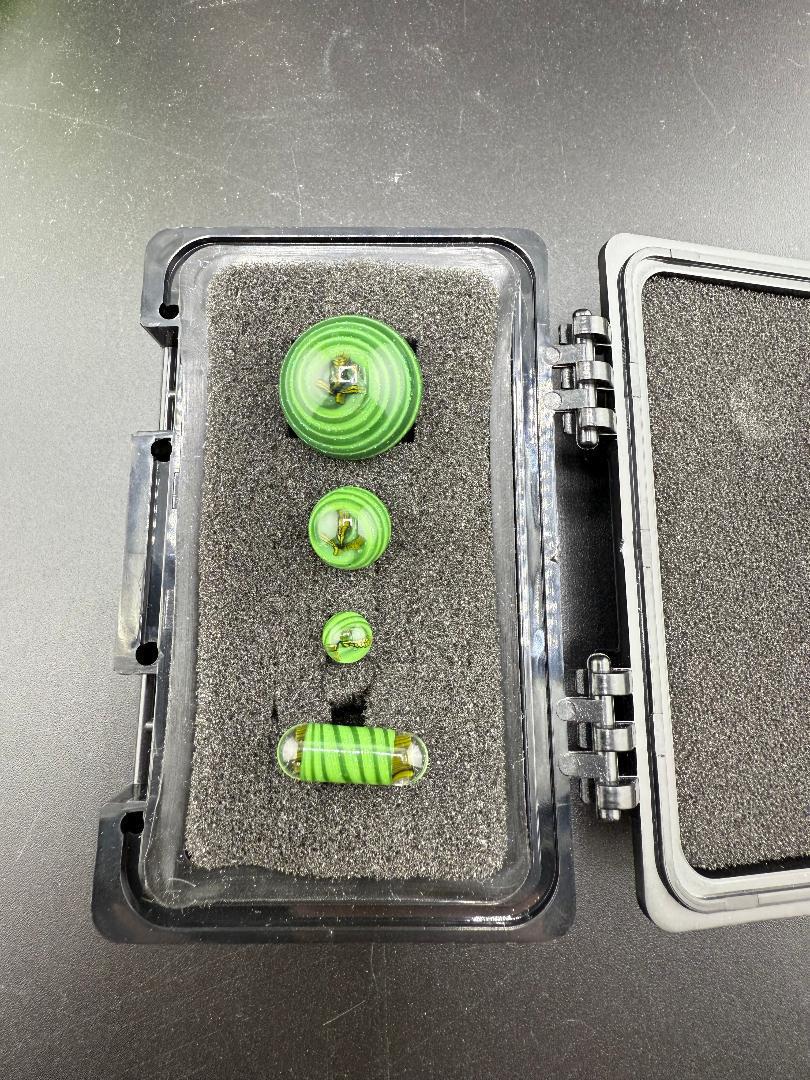 Mr. Gray Glass Millie Pearl Set in a protective case, showcasing handcrafted green millie designs for precise dab functionality.