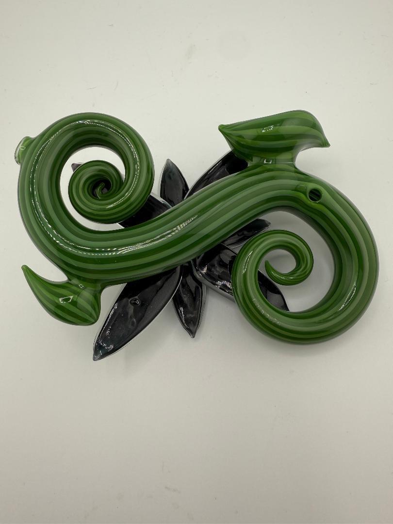 Filla John Spring 2025 Organic Bloom Dichroic Pipe in green glass with elegant botanical design accents.