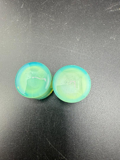 Handcrafted 3/4" Mop Head Glass Gauges in blue and green swirl design, showcasing bold artistry and premium craftsmanship.