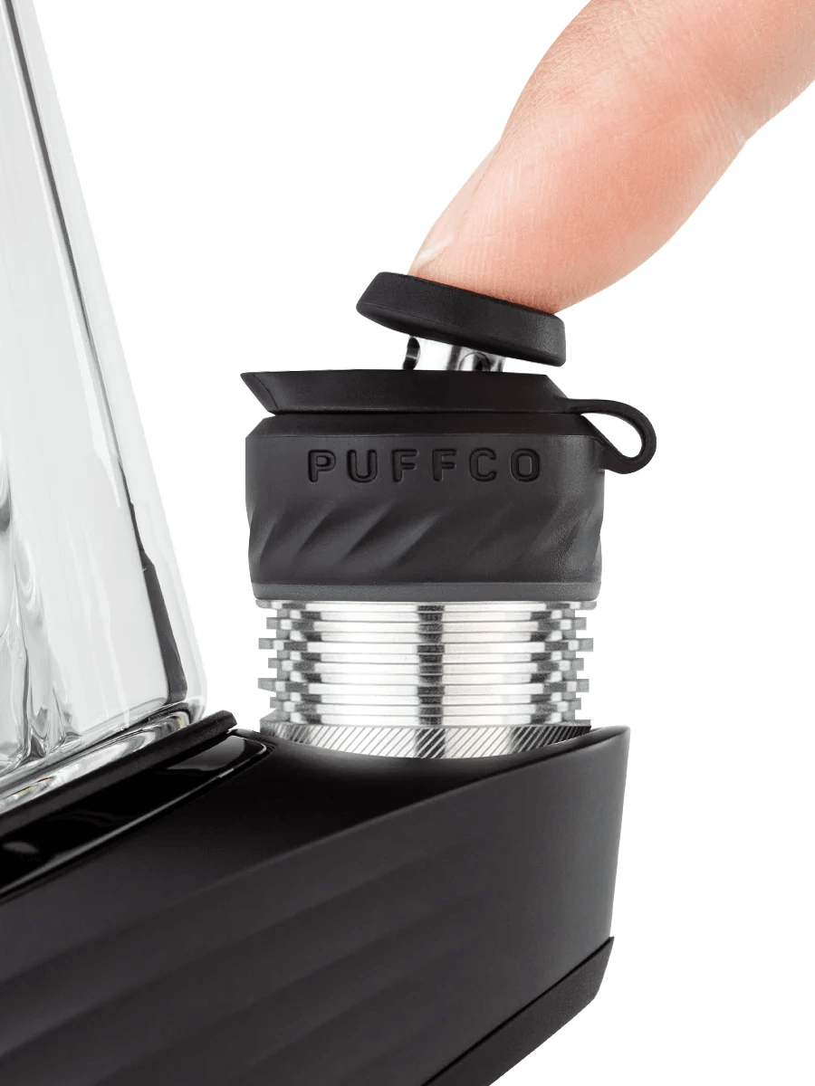 Close-up of Puffco Peak Pro 3DXL with finger pressing the joystick cap for enhanced usability.