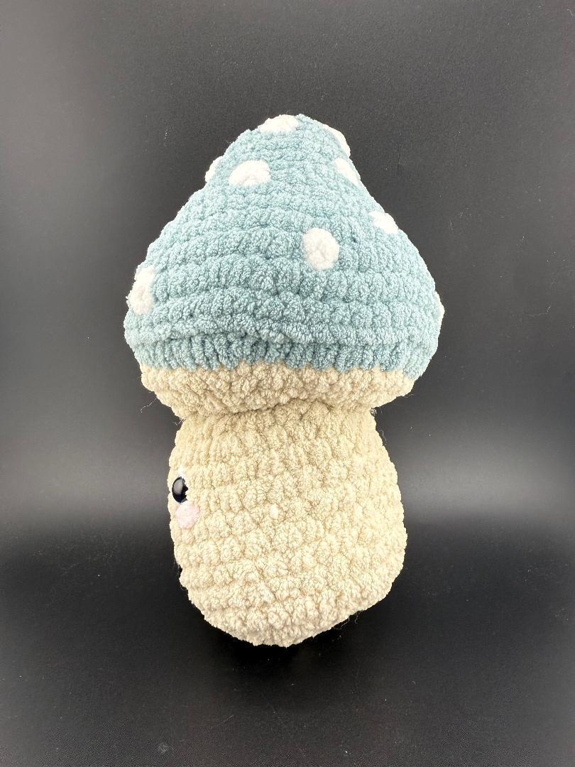 Crochet Mushroom Plushy with blue polka dot cap and beige base, perfect for cozy decor or gifting.
