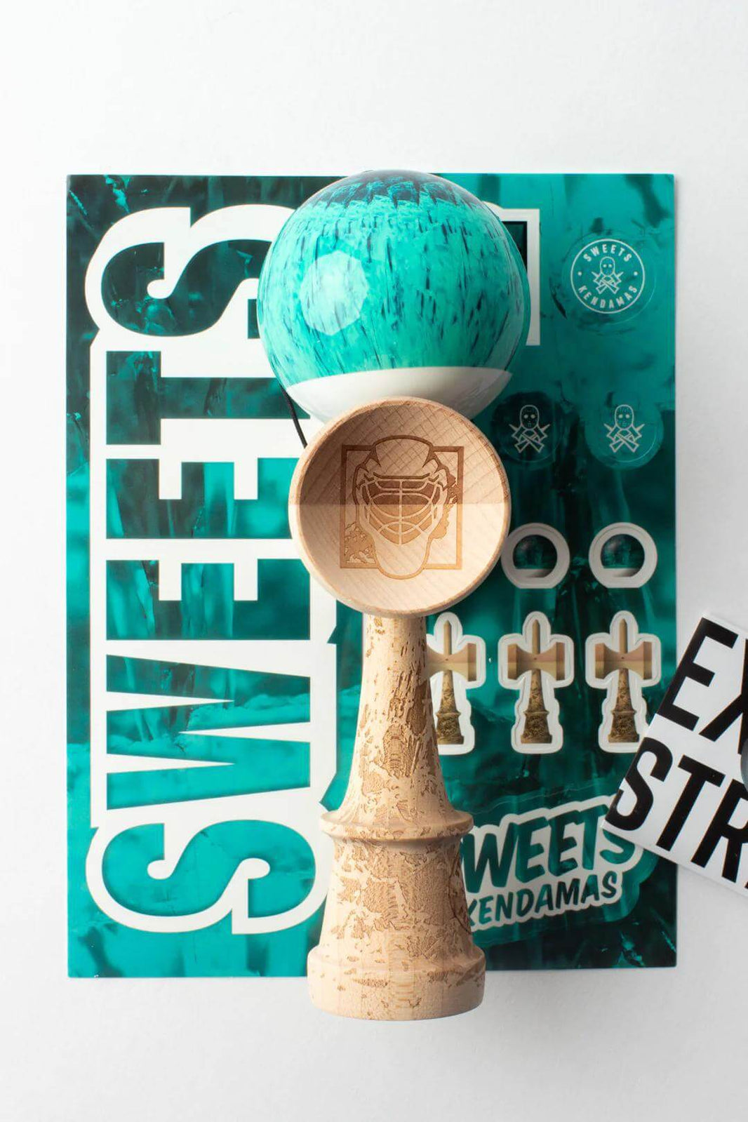 Sweets Kendama Brandon Meyer Pro Model featuring teal tama, maple spike, and engraved design on base.