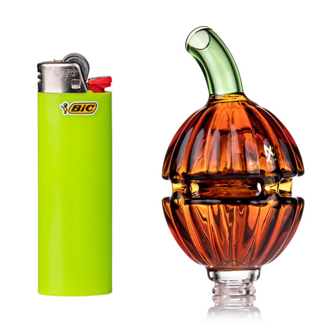 MJ Arsenal Puffco Pivot Top-Gourdy beside a bright green BIC lighter, showcasing the festive gourd design.