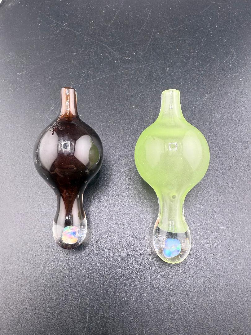 Windstar Glass Bubble Caps in dark brown and green, designed for precise airflow control in dabbing.