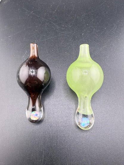 Windstar Glass Bubble Caps in dark brown and green, designed for precise airflow control in dabbing.