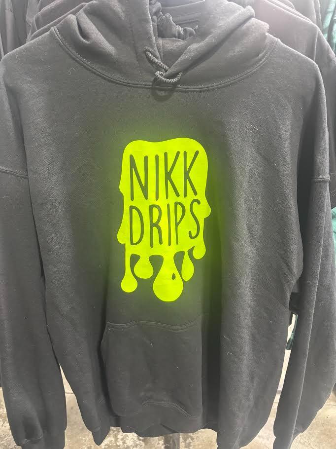 Nikk Drips Hoodie with Vinyl Logo displayed on a hanger, featuring a bold black design and vibrant yellow logo.