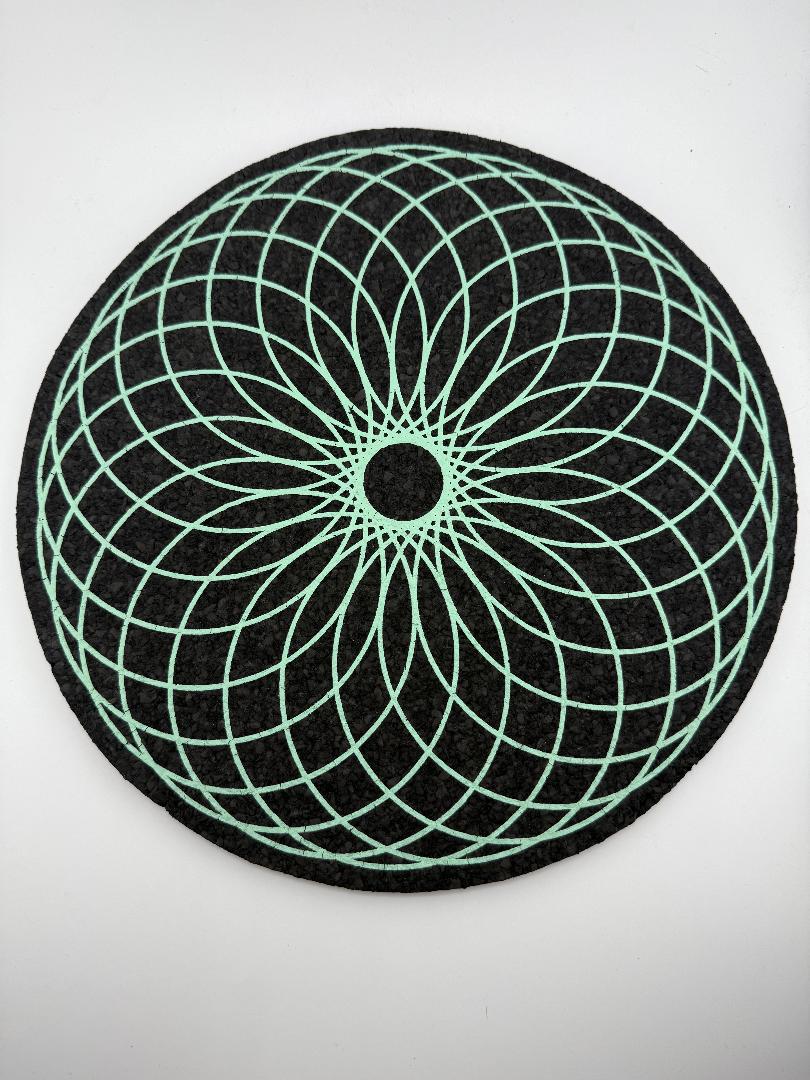 MoodMats Foam Torus 12" with green geometric design on a black background, featuring UV-reactive screen printing.
