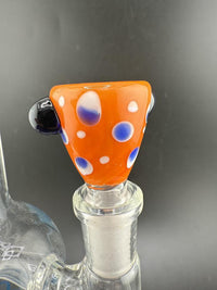 Polka dot 14mm bowl in vibrant orange with blue and white dots, perfect for enhancing your smoking experience.
