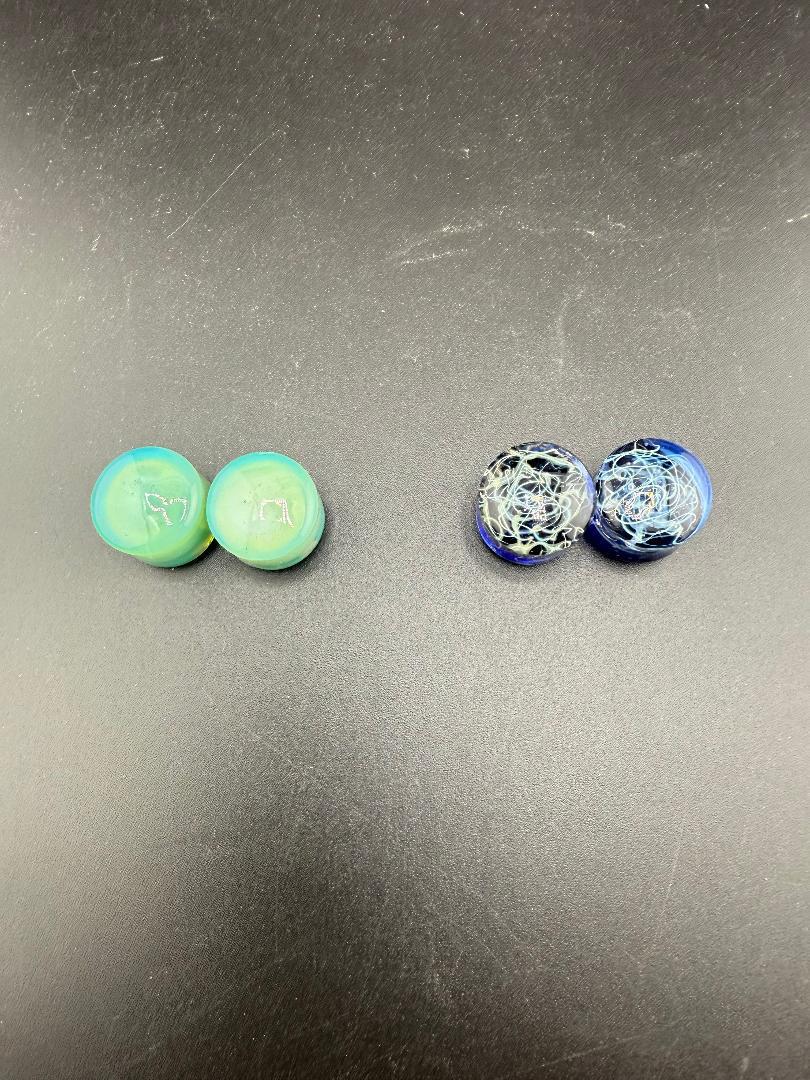 Handcrafted Mop Head Glass Gauges in turquoise and blue swirl designs, showcasing artistic ear plugs for unique expression.