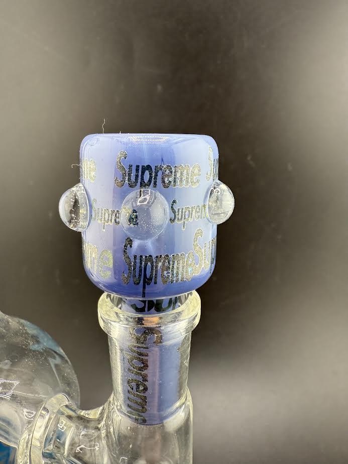 Close-up of a 14mm Supreme Bowl featuring a blue design and engraved details for stylish smoking setups.
