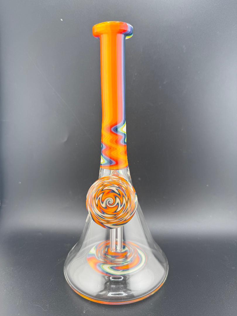 Filla John Glass Circus Beaker with rainbow colors and 10mm 45° joint, offering smooth hits and vibrant design.