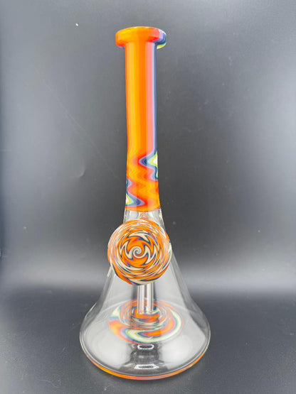 Filla John Glass Circus Beaker with rainbow colors and 10mm 45° joint, offering smooth hits and vibrant design.