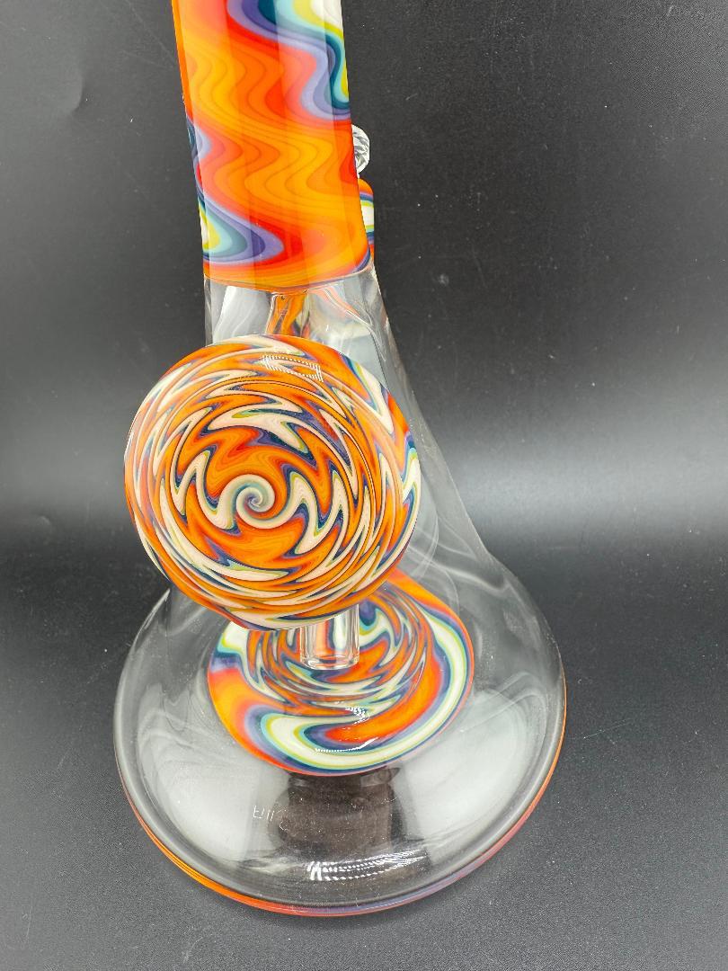 Filla John Glass Circus Beaker with rainbow swirl design and 10mm 45° joint, showcasing vibrant colors and durable glass.