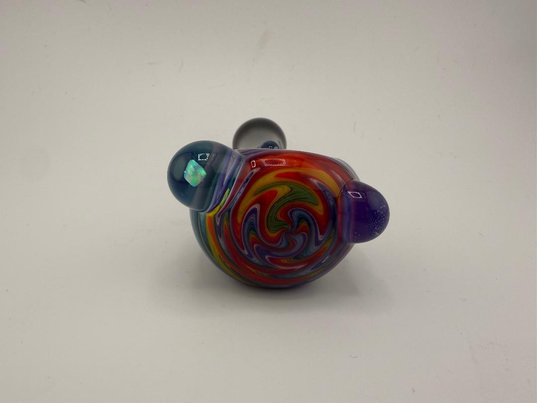 Highgrade Glass Rainbow Wig Wag Spoon pipe featuring vibrant colors and intricate spring reversal pattern.