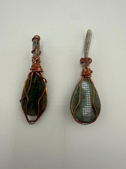 Two handcrafted wire-wrapped labradorite pendants showcasing natural beauty and unique artistry.