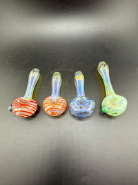 Four colorful hand-blown glass pipes featuring vibrant striped designs on a black background.