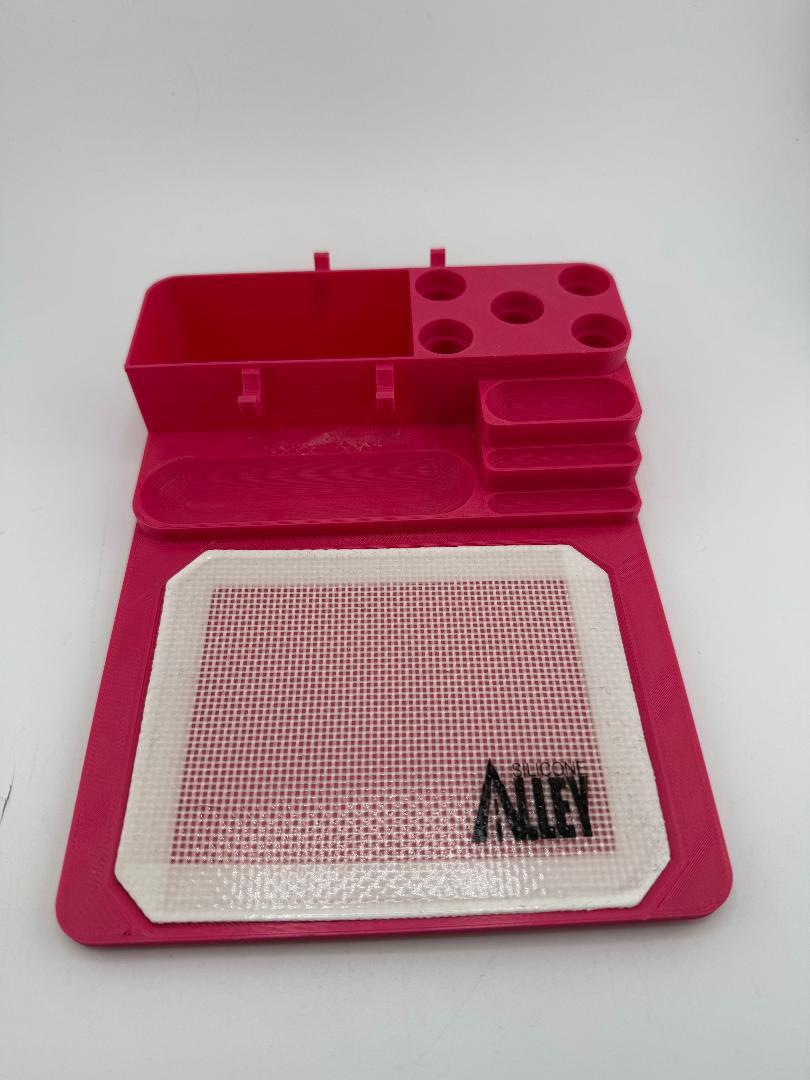 Nikk Drips 3D Printed Dab Station in pink with silicone slick work area and tool slots.