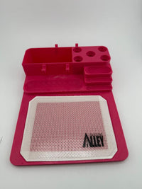 Nikk Drips 3D Printed Dab Station in pink with silicone slick work area and tool slots.