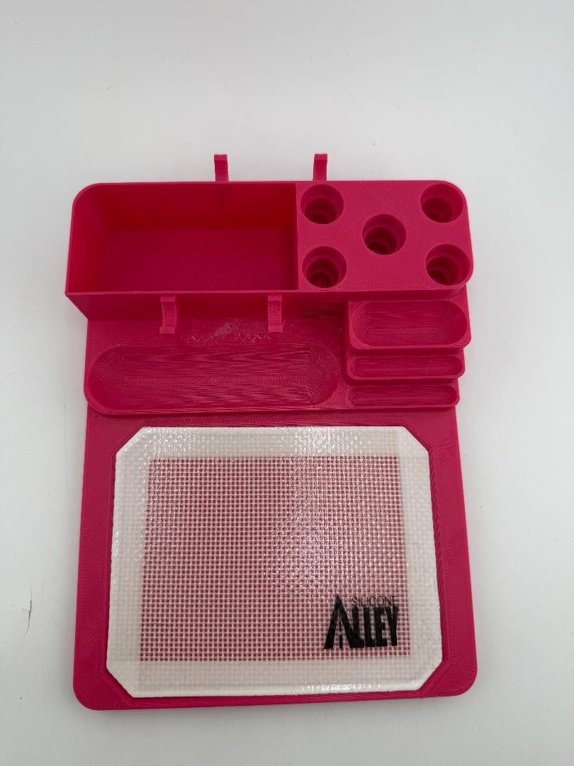 Nikk Drips 3D Printed Dab Station in vibrant pink with compartments and silicone slick work area.