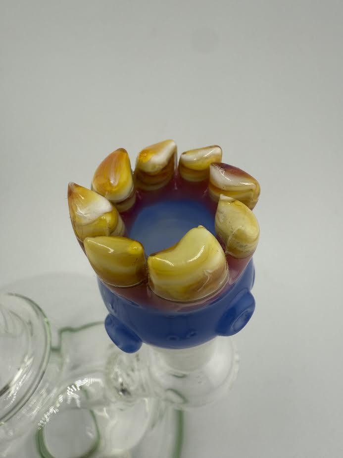 Detailed 14mm glass bowl piece with sculpted teeth by Lamp Dancer, showcasing unique amber and blue colors.