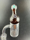 Windstar Glass Bubble Cap atop a clear quartz banger, designed for enhanced airflow and vaporization during dabbing.