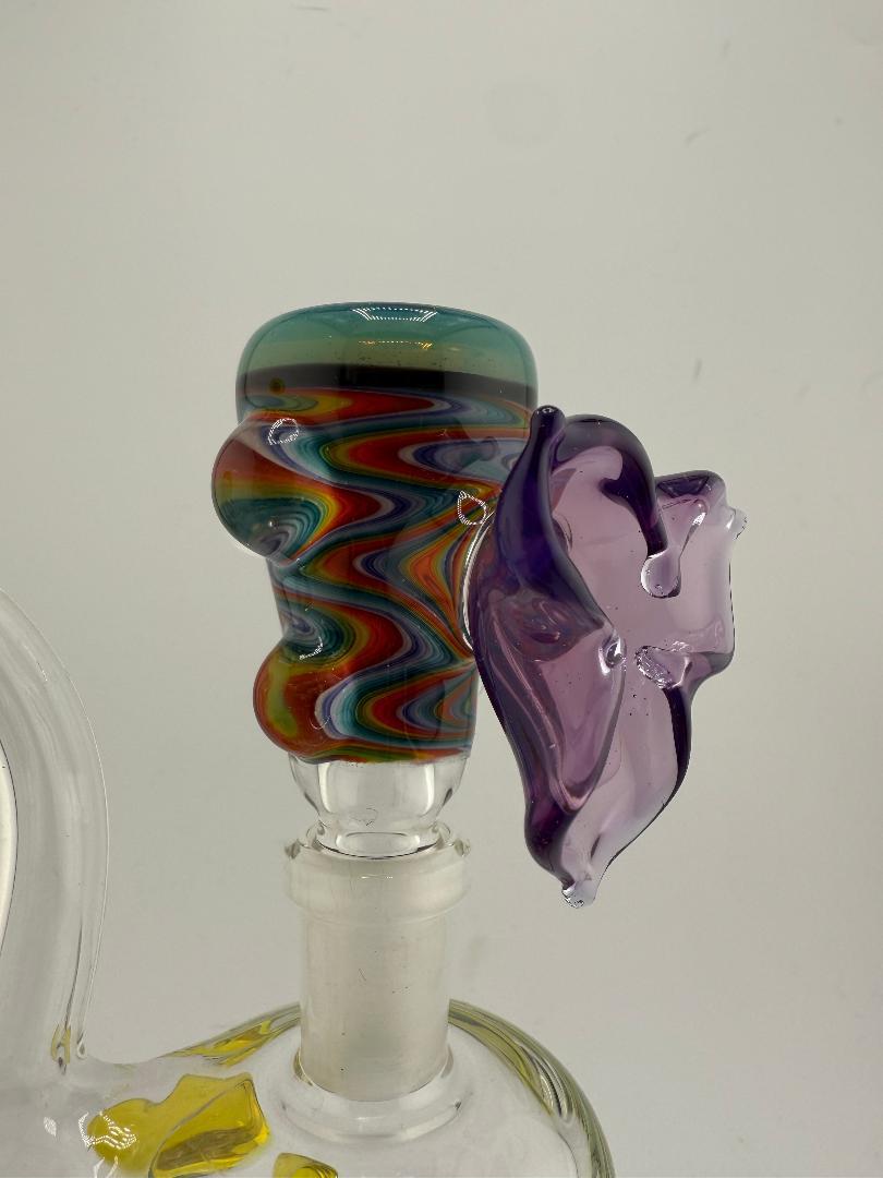 Vibrant 14mm handcrafted glass slide with colorful swirl design and purple accent for smooth sessions.