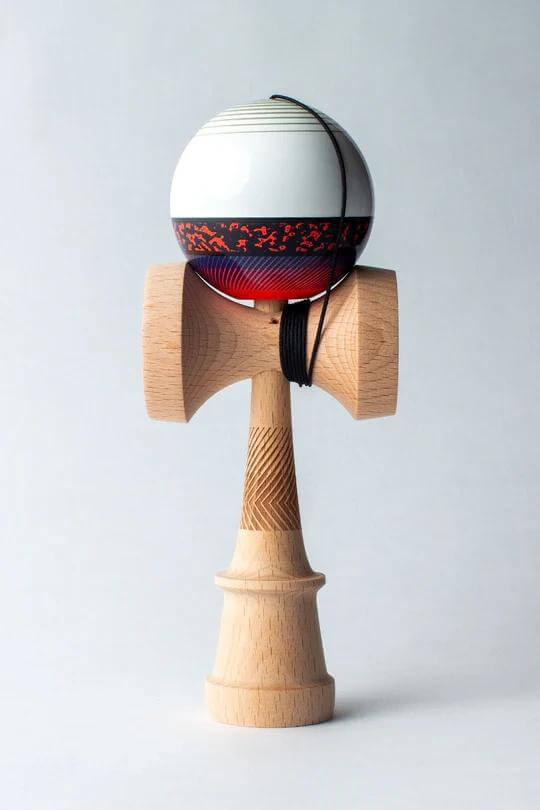 Sweets Kendama Illusion Amped, a stylish and distinctive kendama with a white and red design, featuring full beech construction.