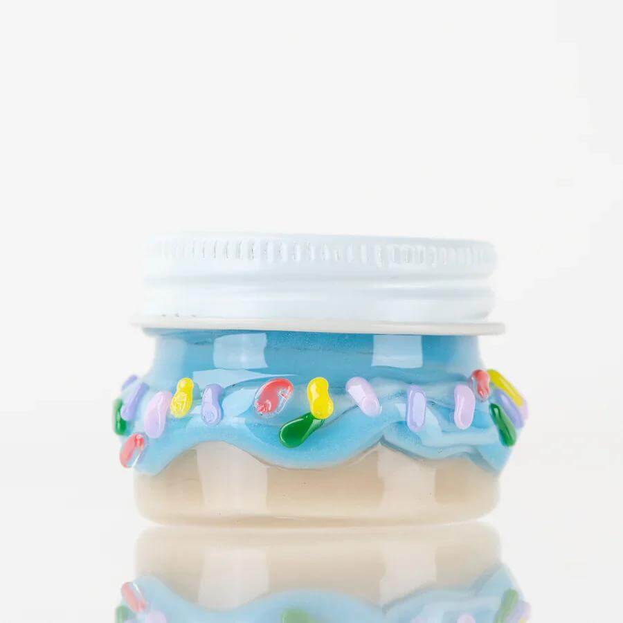 Colorful Empire Glassworks Terp Jar with blue frosting design and sprinkles, perfect for storing terpenes.