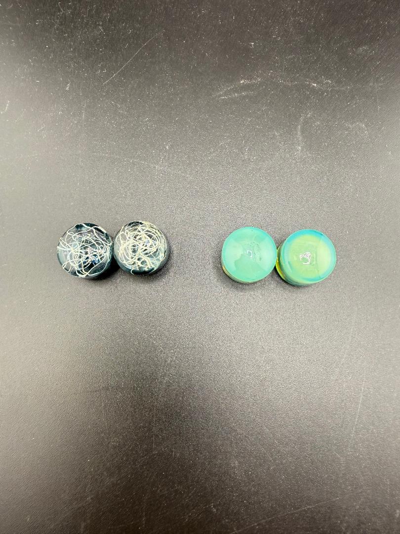 Handcrafted borosilicate glass gauges, 11/16" size, featuring unique designs in blue and green hues.
