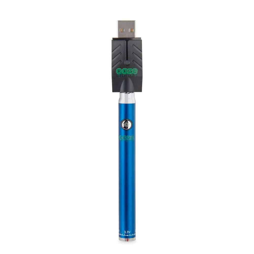 Ooze Twist Pen Slim in blue color with USB charger, ideal for vaping oil cartridges and wax attachments.