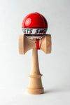 Sweets Kendama Starter in red, featuring a wooden body and sticky clear finish, ideal for beginners learning kendama.