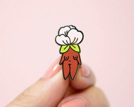 Cute enamel pin featuring a whimsical design of a flower and a figure, by Little Woman Goods Enamel Pins.