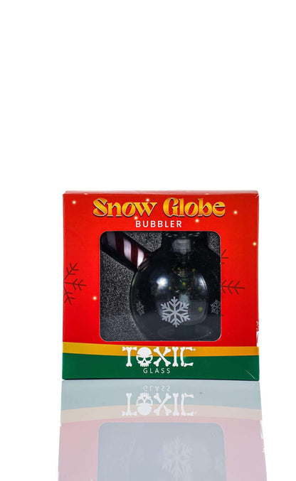 Toxic Glass 3" Snow Globe Bubbler packaging design with snowflakes and festive colors.