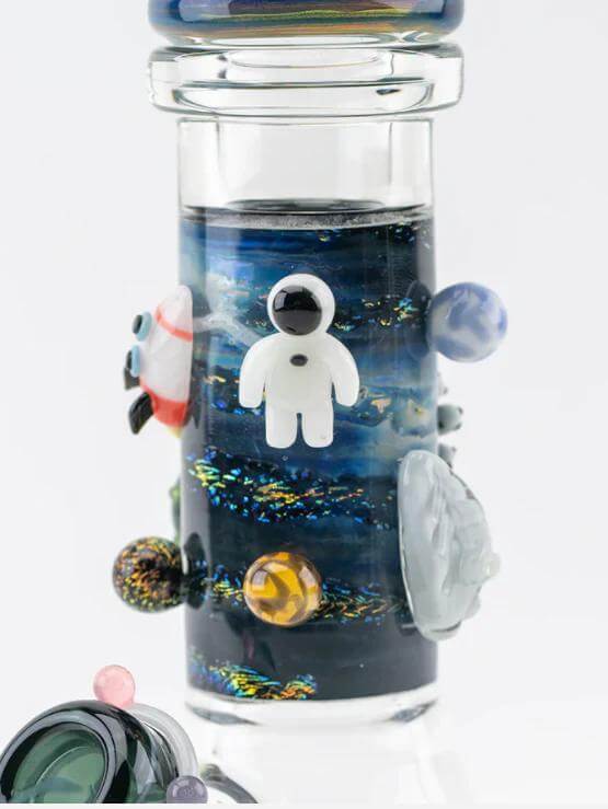 Detail of Empire Glassworks UV Galactic Baby Beaker with astronaut and colorful cosmic designs.